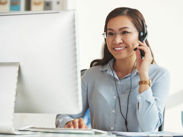 Smiling business lady working in call center